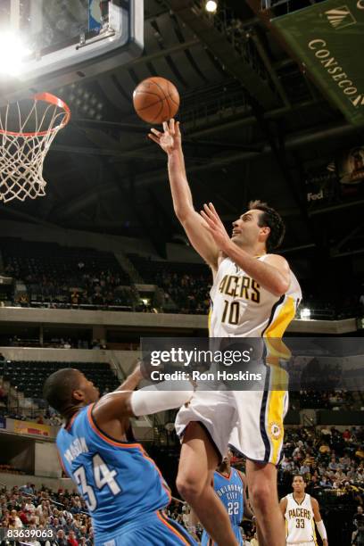 Jeff Foster of the Indiana Pacers scores over Desmond Mason of the Oklahoma City Thunder at Conseco Fieldhouse on November 10, 2008 in Indianapolis,...