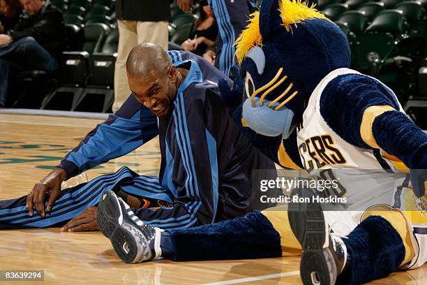 Joe Smith of the Oklahoma City Thunder has some fun with Boomer, the Indiana Pacers mascot prior to the Thunder taking on the Pacers at Conseco...