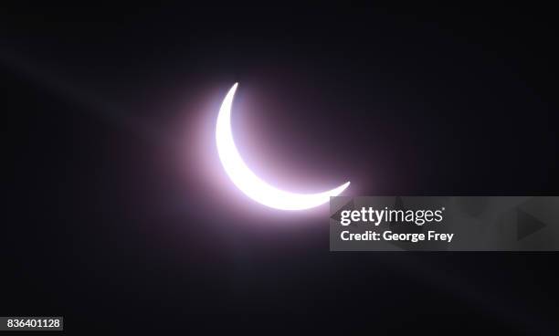 The sun is partially eclipsed in the first phase of a total eclipse in Grand Teton National Park on August 21, 2017 outside Jackson, Wyoming....