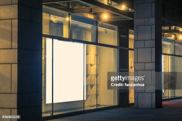 night view of the mall in qingdao,china - high end store fronts stock-fotos und bilder