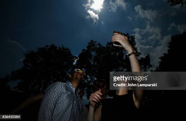 People view the Solar Eclipse at Battery Park on August 21, 2017 in New York, New York.