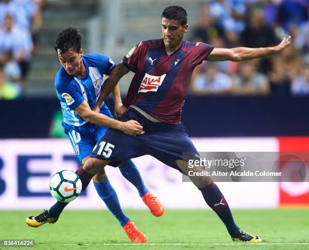 Juan Pablo Anor "Juanpi" of Malaga CF competes for the ball with Jose Angel Valdes "Cote" of SD Eibar during the La Liga match between Malaga and...