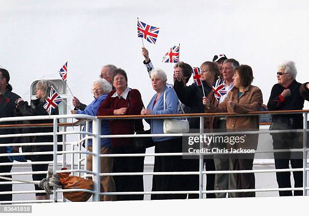 People waves Union Jacks as The Queen Elizabeth II docks ahead of its final voyage to Dubai on November 11, 2008 in Southampton, England. The Ship...