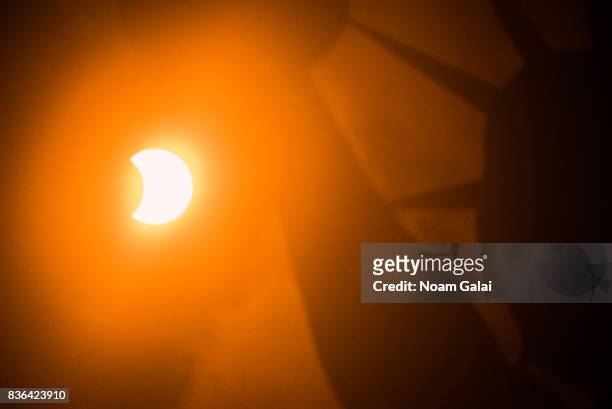 The solar eclipse is seen behind the Statue of Liberty at Liberty Island in on August 21, 2017 in New York City. While New York was not in the path...