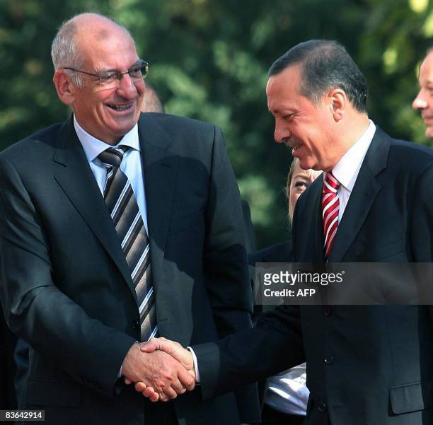 Switzerland's President Pascal Couchepin is welcomed by Turkish Prime Minister Recep Tayyip Erdogan before their meeting in Ankara, on November 11,...