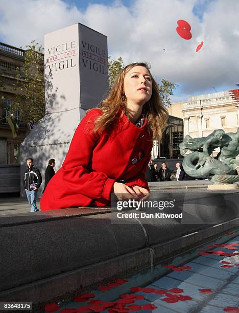 Singer Hayley Westenra casts poppies into the fountain in Trafalgar Square after observing a two minute silence for the Armistice day commemorations...