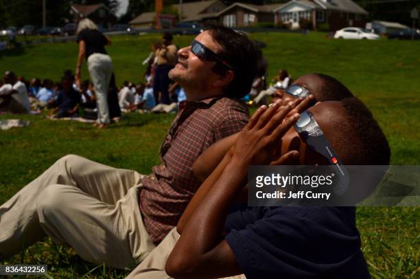 Students at the Jennings School District view the solar eclipse with Edgar Aguilar of Mastercard on August 21, 2017 in St Louis, Missouri.