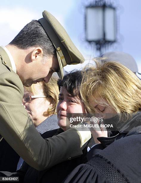 Spanish Prince Felipe comforts the relatives of Ruben Alonso Rios and Juan Andres Suarez Garcia, the two Spanish soldiers who were killed on November...