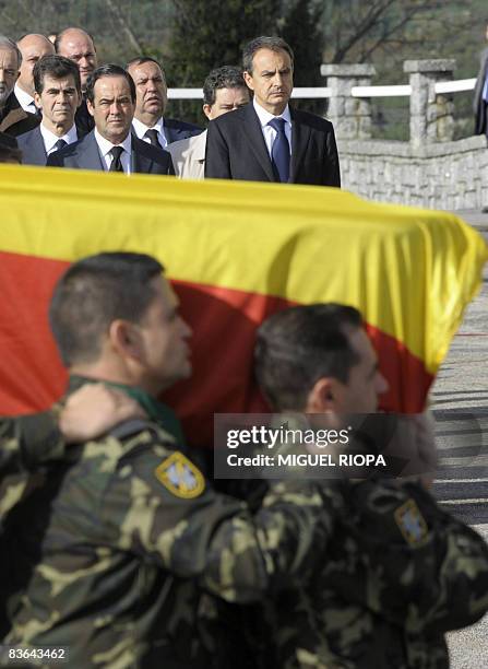 Spanish Prime Minister Jose Luis Rodriguez Zapatero watches soldiers carry the coffins of Ruben Alonso Rios and Juan Andres Suarez Garcia, the two...