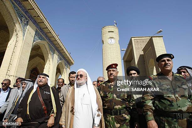 Salih al-Haidari , the head of Iraq's Shiite religious endowments, walks with General Abud Qanbar , the head of the Baghdad security plan, in the...