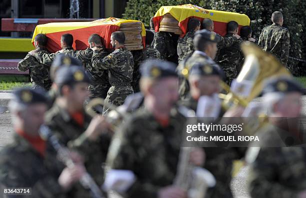 Spanish soldiers carry the coffins of their two comrades killed in a Taliban suicide attack in Afghanistan, Ruben Alonso Rios and Juan Andres Suarez...