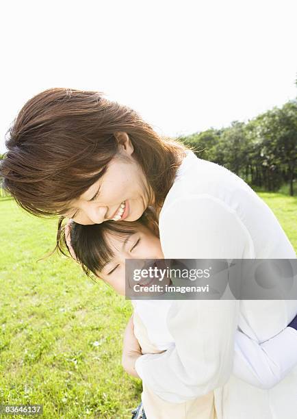 interaction between mother and daughter - woman smiling facing down stock pictures, royalty-free photos & images
