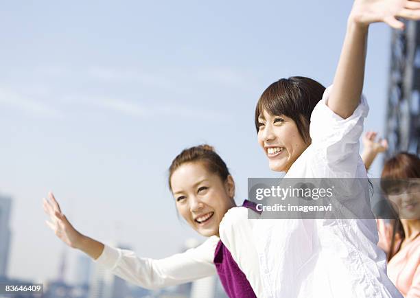 women waving their hands - 振る ストックフォトと画像