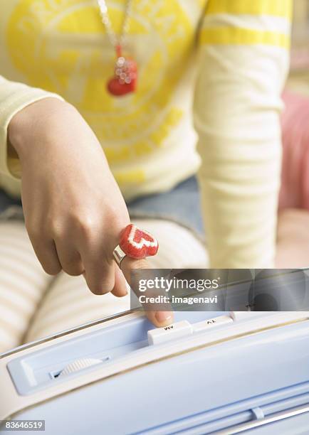 a woman pushing button of the radio - zeigefinger ring stock-fotos und bilder