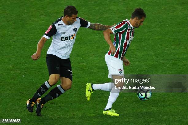 Lucas of Fluminense struggles for the ball with Rafael Moura of Atletico MG during a match between Fluminense and Atletico MG part of Brasileirao...