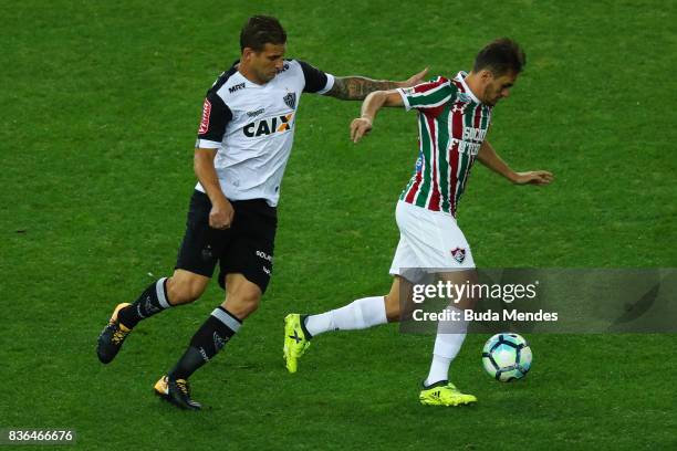 Lucas of Fluminense struggles for the ball with Rafael Moura of Atletico MG during a match between Fluminense and Atletico MG part of Brasileirao...
