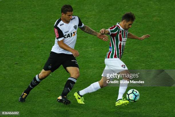 Lucas of Fluminense struggles for the ball with Rafael Moura of Atletico MG during a match between Fluminense and Atletico MG part of Brasileirao...