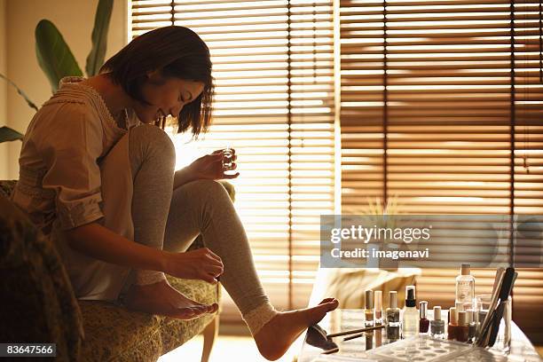 a woman having a pedicure - woman smiling facing down stock pictures, royalty-free photos & images