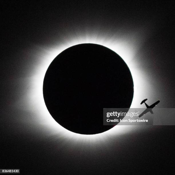 Small plane is silhouetted by the eclipse as it flies thru the path of totality on August 21, 2017 in Saluda, South Carolina.