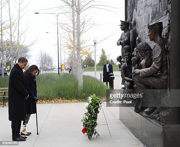 President-elect Barack Obama and Gulf War veteran Tammy Duckworth both their heads after placing a wreath to honor America's veterans on Veterans Day...