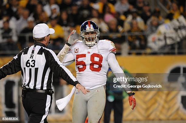 Linebacker Antonio Pierce of the New York Giants talks with referee Bill Carollo during a game against the Pittsburgh Steelers at Heinz Field on...