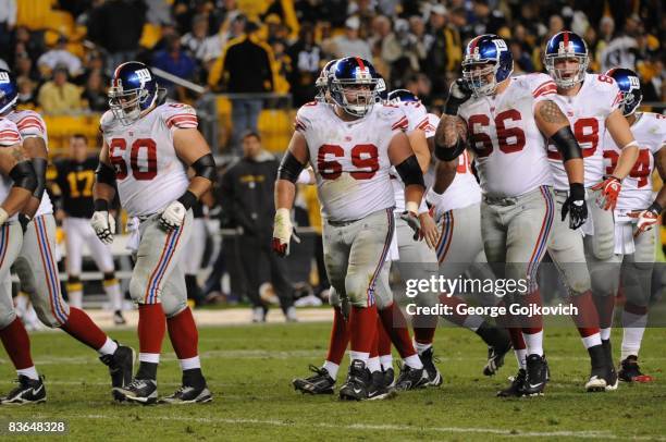 Offensive linemen Shaun O'Hara, Rich Seubert and David Diehl of the New York Giants walk to the line of scrimmage during a game against the...