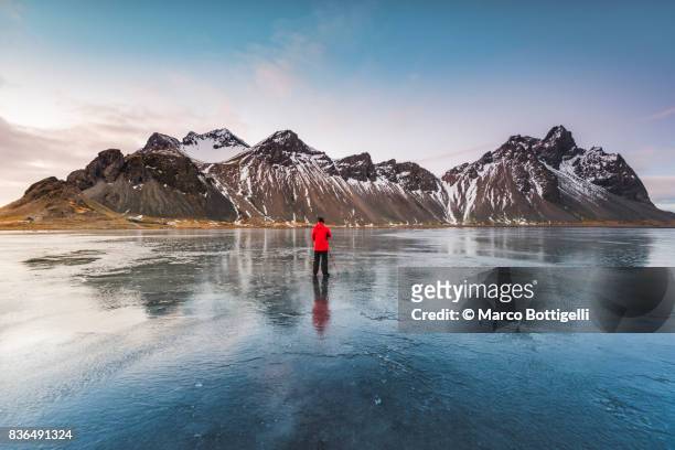 tourist photographer at stokksnes. iceland. - photographer taking pictures nature stock pictures, royalty-free photos & images