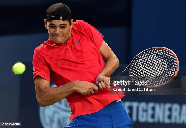 Taylor Fritz returns a shot from Malek Jaziri of Tunisia during the third day of the Winston-Salem Open at Wake Forest University on August 21, 2017...