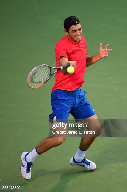 Taylor Fritz returns a shot from Malek Jaziri of Tunisia during the third day of the Winston-Salem Open at Wake Forest University on August 21, 2017...