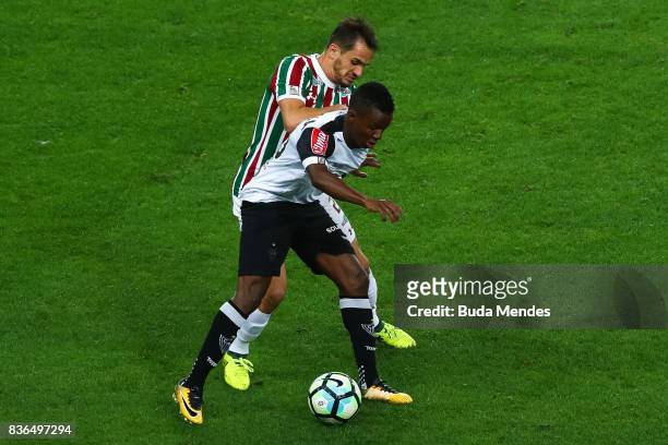 Lucas of Fluminense struggles for the ball with Cazares of Atletico MG during a match between Fluminense and Atletico MG part of Brasileirao Series A...