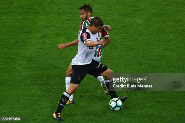 Gustavo Scarpa of Fluminense struggles for the ball with Rafael Moura of Atletico MG during a match between Fluminense and Atletico MG part of...