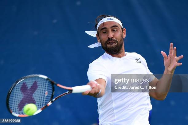 Marcos Baghdatis of Cyprus returns a shot from Jiri Vesely of Czech Republic during the third day of the Winston-Salem Open at Wake Forest University...