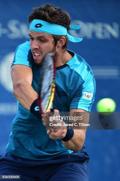 Jiri Vesely of Czech Republic returns a shot from Marcos Baghdatis of Cyprus during the third day of the Winston-Salem Open at Wake Forest University...