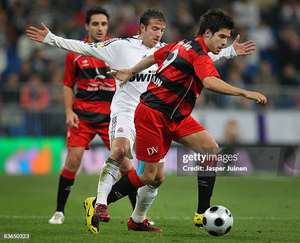 Paul Abasolo of Real Union duels for the ball with Rafael van der Vaart of Real Madrid during the round of last 16, second leg Copa del Rey match...