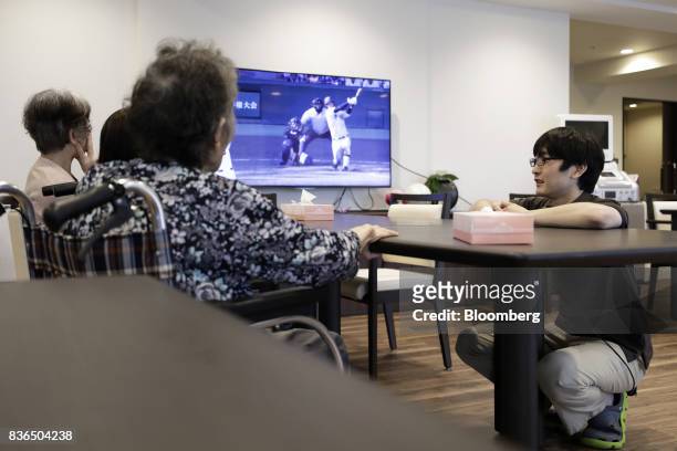 Nursing care worker, right, speaks to residents at the As Partners Co. Asheim Nerima Garden nursing home in Tokyo, Japan, on Friday, Aug. 18, 2017....