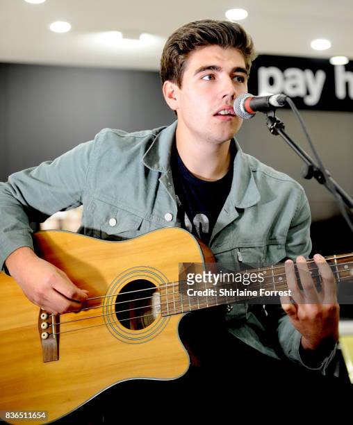 Andy Davidson of The Sherlocks performs live and signs copies of their debut album 'Live for the Moment' during an instore session at HMV Manchester...