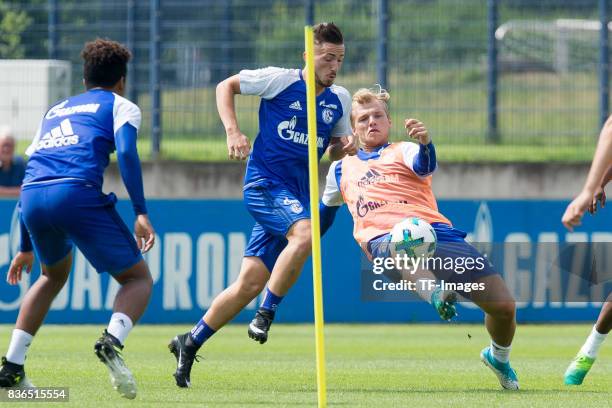 Donis Avdijaj of Schalke and Johannes Geis of Schalke battle for the ball during a training session at the FC Schalke 04 Training center on July 5,...