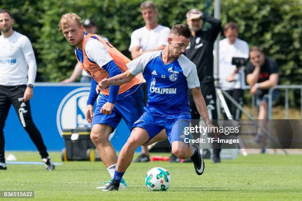 Johannes Geis of Schalke and Donis Avdijaj of Schalke battle for the ball during a training session at the FC Schalke 04 Training center on July 5,...