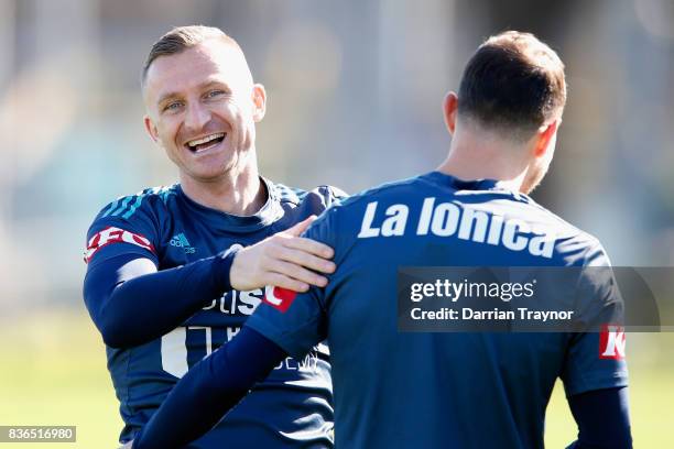 Besart Berisha and James Troisi of the Victory share a laugh during a Melbourne Victory training session at AAMI Park on August 22, 2017 in...