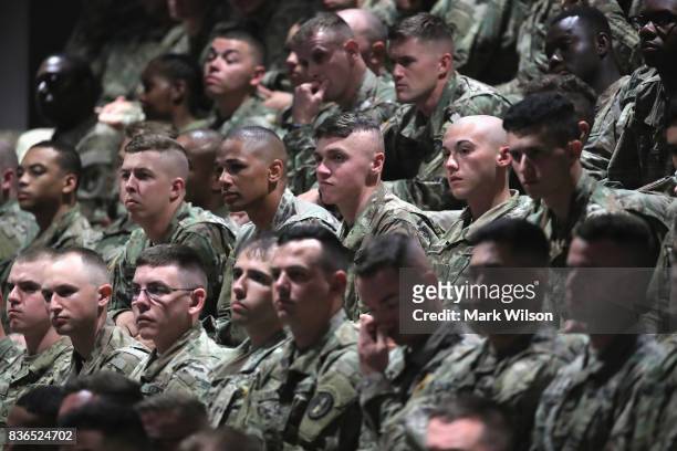 Military personnel listen to President Donald Trump deliver remarks on Americas involvement in Afghanistan at the Fort Myer military base on August...