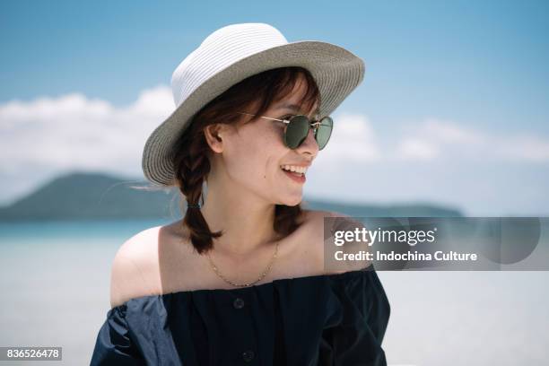 beautiful vietnamese young woman with a lovely toothy smile on the beach - vietnam beach stockfoto's en -beelden