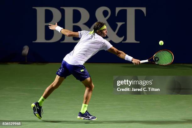 Malek Jaziri of Tunisia returns a shot from Taylor Fritz during the third day of the Winston-Salem Open at Wake Forest University on August 21, 2017...