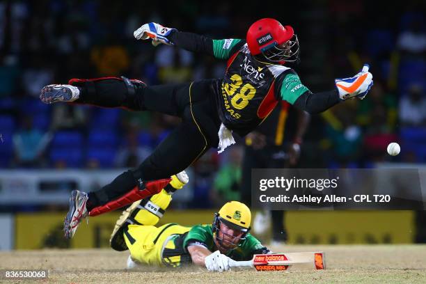 In this handout image provided by CPL T20, Devon Thomas of St Kitts and Nevis Patriots is airborne as he attempts to gather for a run out attempt on...