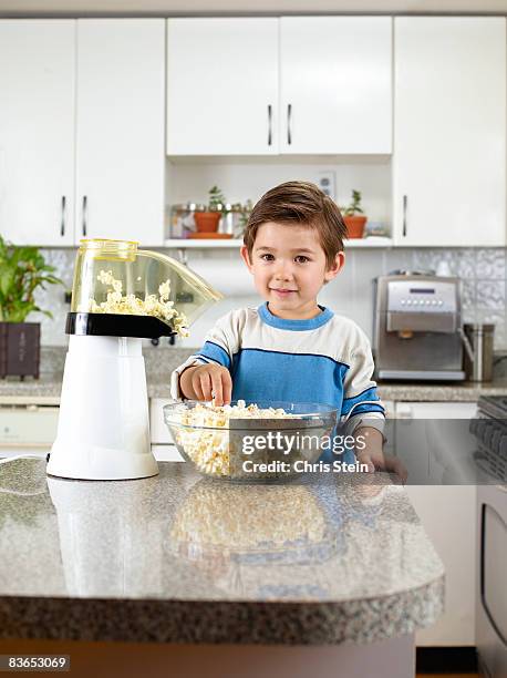 boy eating popcorn - popcorn machine stock pictures, royalty-free photos & images