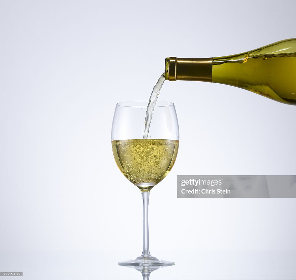 White wine pouring into wineglass