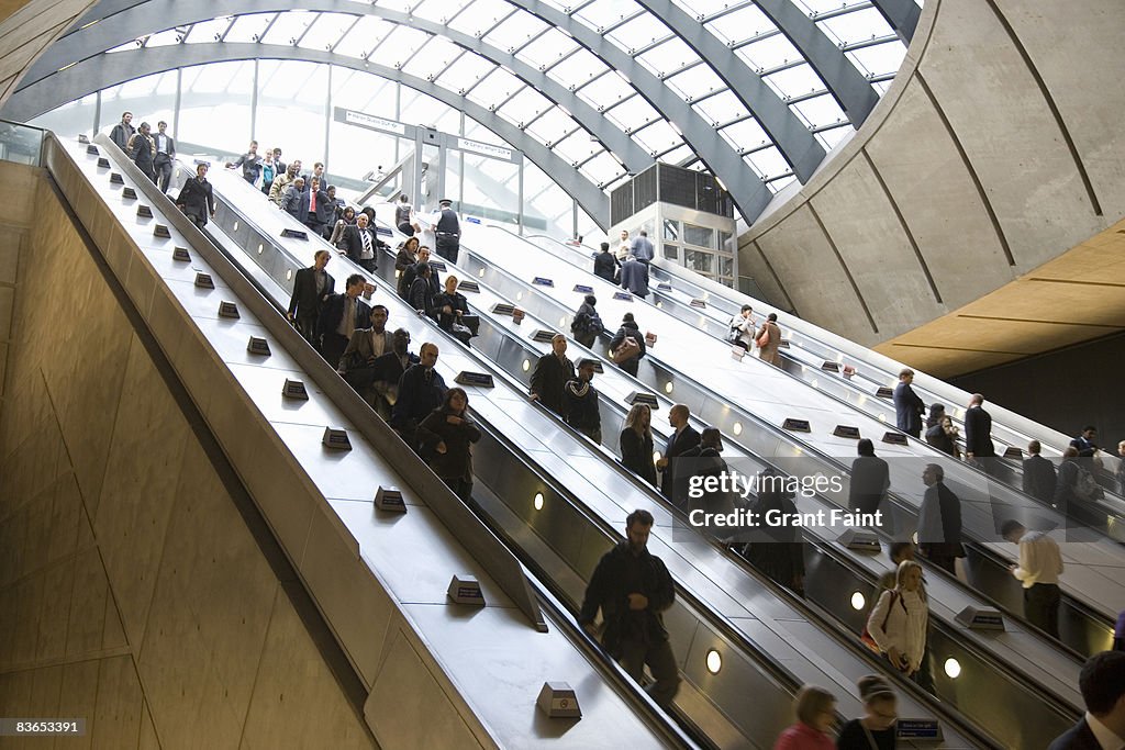 Commuters using escalator getting to subway