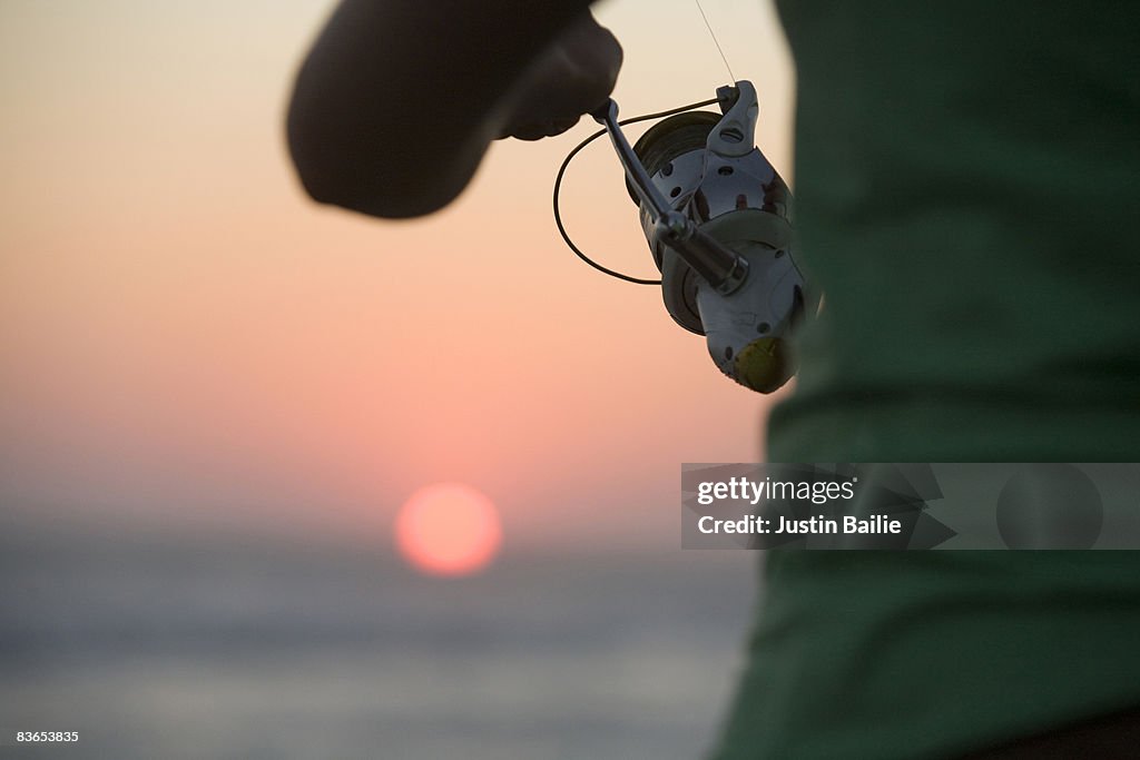 Fishing on beach at sunset Mexico.