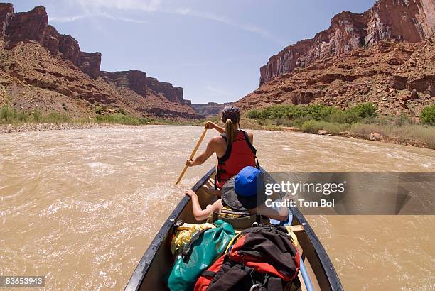 canoeing on the colorado river - family red canoe stock pictures, royalty-free photos & images