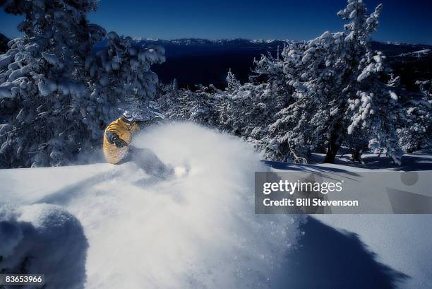snowboarding in powder at lake tahoe - lake tahoe stock pictures, royalty-free photos & images