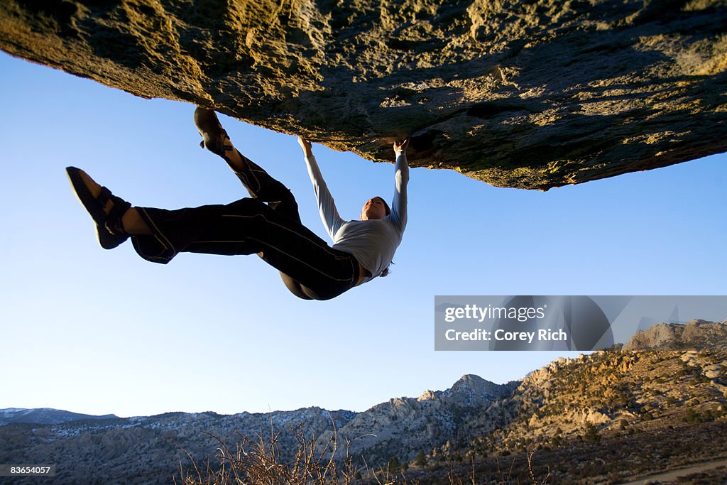 Woman bouldering on an overhang